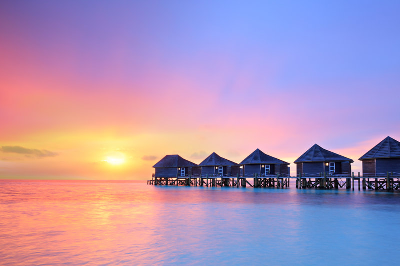 Over water bungalows at sunset